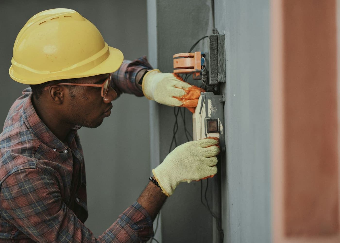 Technician installing low-voltage security control equipment
